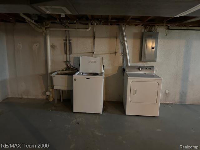 5936 Meadowview St, Ypsilanti, MI 48197 - unfinished below grade area featuring electric panel, washing machine and clothes dryer, and a sink