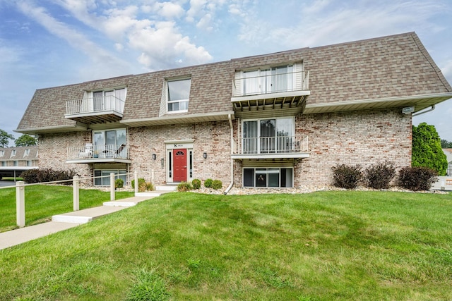 3626 Lakeshore Dr Unit K10, Saint Joseph, MI 49085 - view of front facade featuring a balcony, a shingled roof, and brick siding
