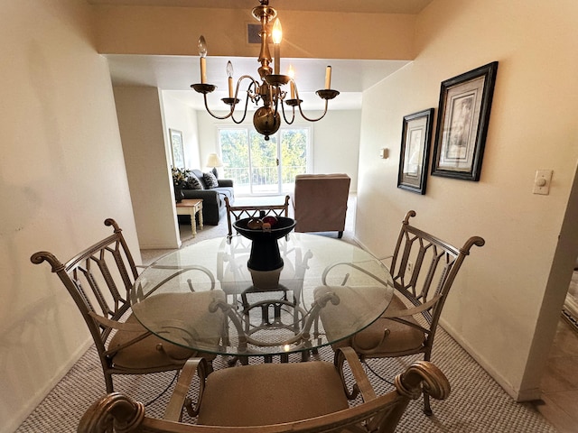 3626 Lakeshore Dr Unit K10, Saint Joseph, MI 49085 - dining area featuring a chandelier, light colored carpet, and baseboards
