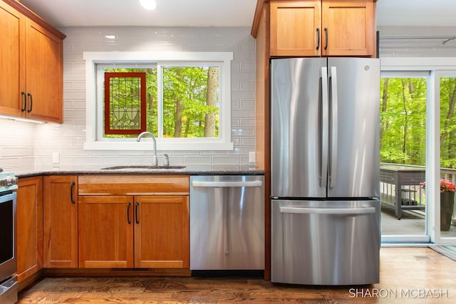3348 Clearview Ln, Saugatuck, MI 49453 - kitchen featuring stainless steel appliances, a sink, healthy amount of natural light, and decorative backsplash