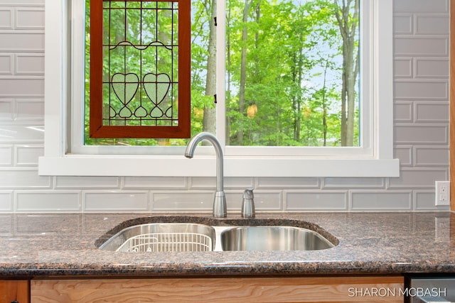 3348 Clearview Ln, Saugatuck, MI 49453 - kitchen view of a sink, backsplash, and dark stone countertops
