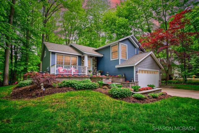 3348 Clearview Ln, Saugatuck, MI 49453 - split level home featuring a porch, driveway, a front yard, and an attached garage