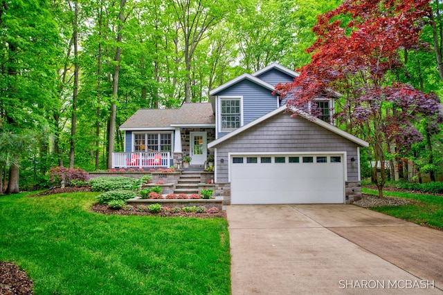3348 Clearview Ln, Saugatuck, MI 49453 - tri-level home with stone siding, driveway, and a front lawn