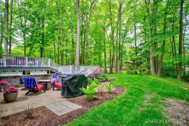 3348 Clearview Ln, Saugatuck, MI 49453 - view of grassy yard featuring a patio area, a deck, a fire pit, and stairs