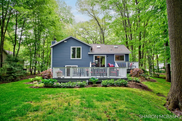 3348 Clearview Ln, Saugatuck, MI 49453 - rear view of property featuring a lawn, a chimney, and a wooden deck