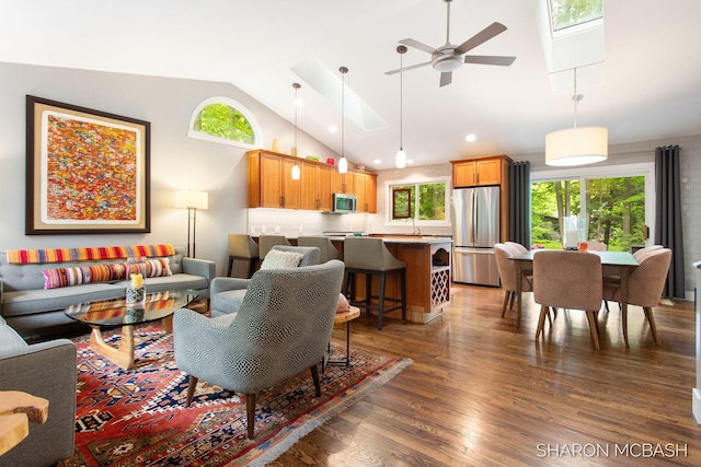 3348 Clearview Ln, Saugatuck, MI 49453 - living room with vaulted ceiling, wood finished floors, ceiling fan, a skylight, and recessed lighting