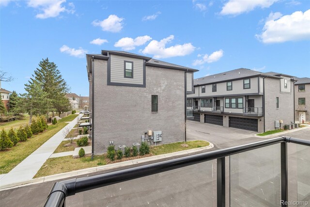2813 Summers Pl, Troy, MI 48084 - view of side of home featuring a balcony, brick siding, and a residential view