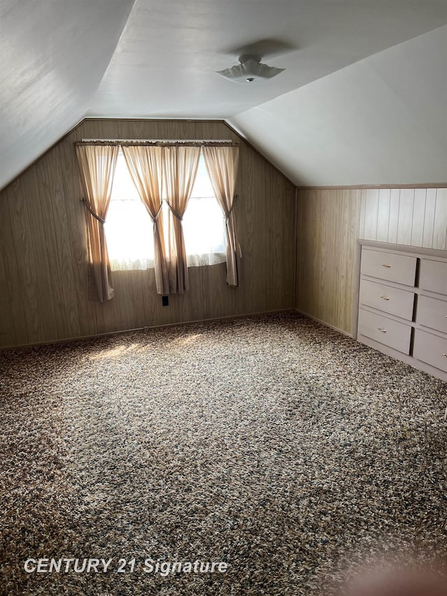 1613 Waldman Ave, Flint, MI 48507 - additional living space with vaulted ceiling, wood walls, and a ceiling fan