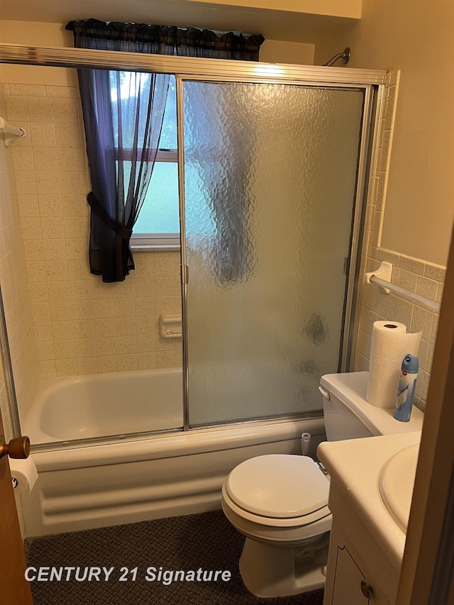 1613 Waldman Ave, Flint, MI 48507 - bathroom featuring vanity, combined bath / shower with glass door, toilet, and tile walls