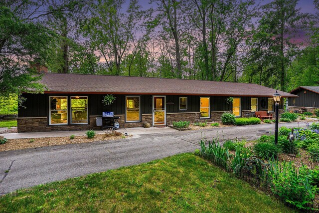 731 13 Mile Rd NW, Sparta, MI 49345 - ranch-style home featuring stone siding, board and batten siding, and a chimney