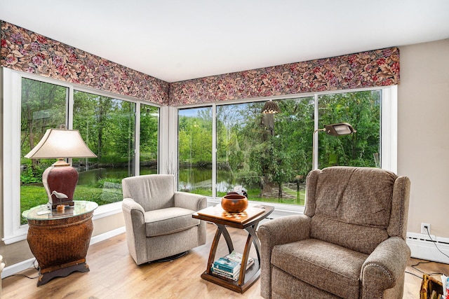731 13 Mile Rd NW, Sparta, MI 49345 - sitting room with light wood-type flooring, a baseboard heating unit, baseboards, and a water view