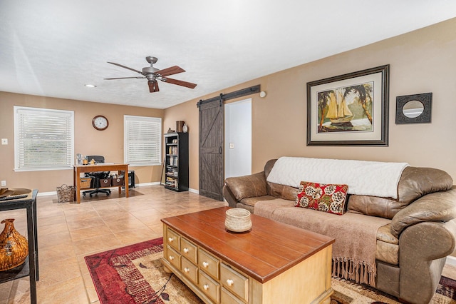 731 13 Mile Rd NW, Sparta, MI 49345 - living room with a barn door, ceiling fan, baseboards, and light tile patterned floors