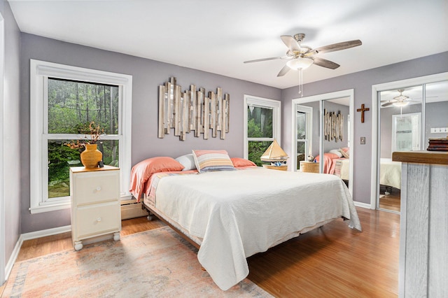 731 13 Mile Rd NW, Sparta, MI 49345 - bedroom featuring multiple windows, baseboards, and light wood finished floors