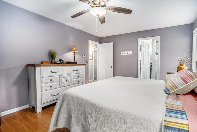 731 13 Mile Rd NW, Sparta, MI 49345 - bedroom featuring baseboards, light wood-style flooring, and ceiling fan