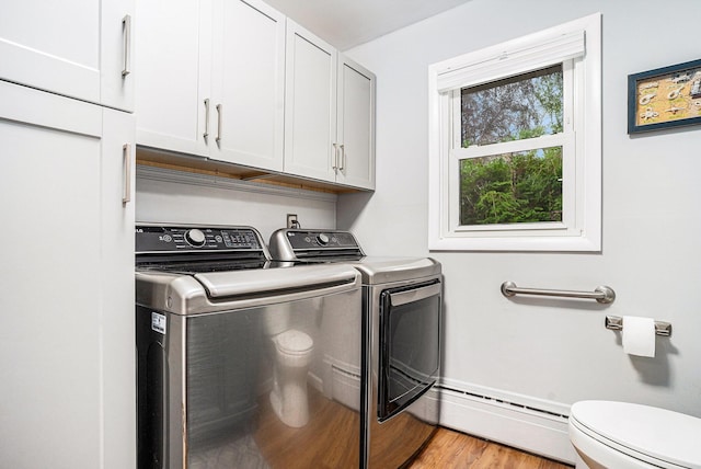 731 13 Mile Rd NW, Sparta, MI 49345 - washroom featuring a baseboard radiator, washer and clothes dryer, wood finished floors, and baseboards