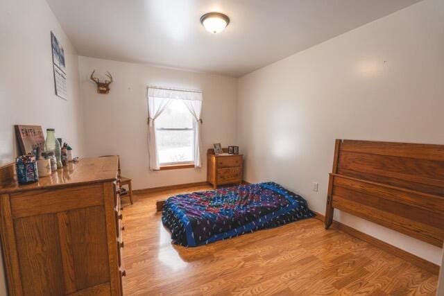 14656 Hersey Rd, Hersey, MI 49639 - bedroom featuring wood finished floors and baseboards