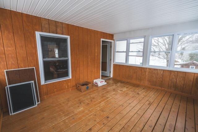 14656 Hersey Rd, Hersey, MI 49639 - unfurnished sunroom with hardwood / wood-style flooring, a wooden deck, and wooden walls