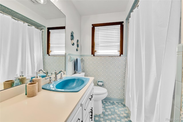 26500 Grant St, Saint Clair Shores, MI 48081 - full bathroom with toilet, vanity, wallpapered walls, healthy amount of natural light, and wainscoting