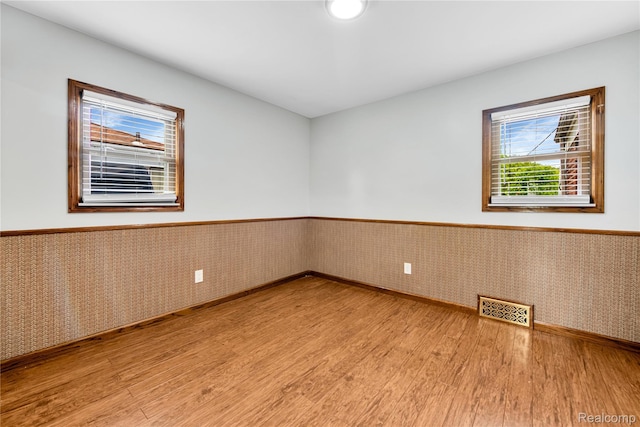 26500 Grant St, Saint Clair Shores, MI 48081 - unfurnished room featuring wood finished floors, wainscoting, and baseboards