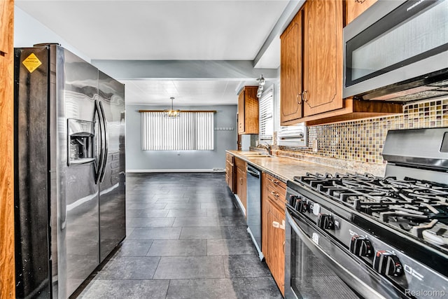 26500 Grant St, Saint Clair Shores, MI 48081 - kitchen featuring appliances with stainless steel finishes, decorative backsplash, brown cabinetry, and light countertops