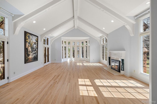 3013 Heron Pl, Bloomfield Hills, MI 48302 - unfurnished living room featuring beamed ceiling, a glass covered fireplace, high vaulted ceiling, light wood-type flooring, and baseboards