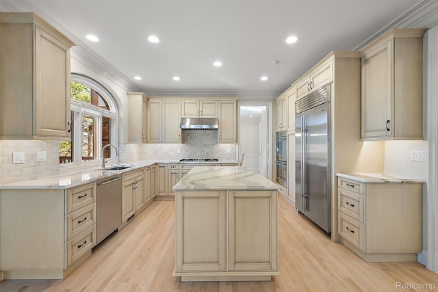 3013 Heron Pl, Bloomfield Hills, MI 48302 - kitchen with appliances with stainless steel finishes, light stone counters, cream cabinets, a kitchen island, and recessed lighting