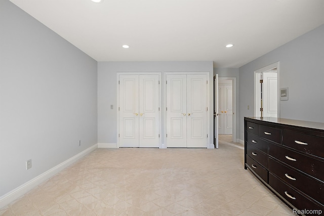 3013 Heron Pl, Bloomfield Hills, MI 48302 - unfurnished bedroom with two closets, baseboards, and recessed lighting