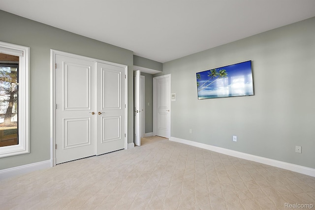 3013 Heron Pl, Bloomfield Hills, MI 48302 - unfurnished bedroom with baseboards, a closet, and light carpet
