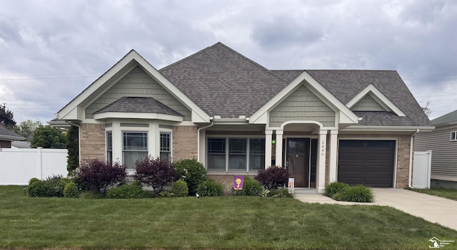 2446 8th St, Wyandotte, MI 48192 - view of front of home featuring concrete driveway, roof with shingles, brick siding, and a garage