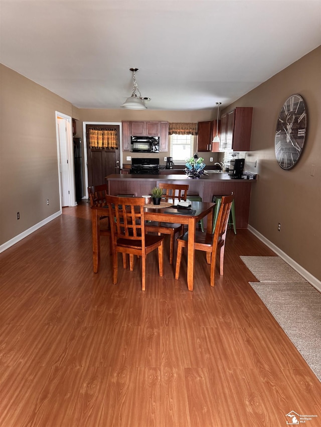 2446 8th St, Wyandotte, MI 48192 - dining area with wood finished floors and baseboards