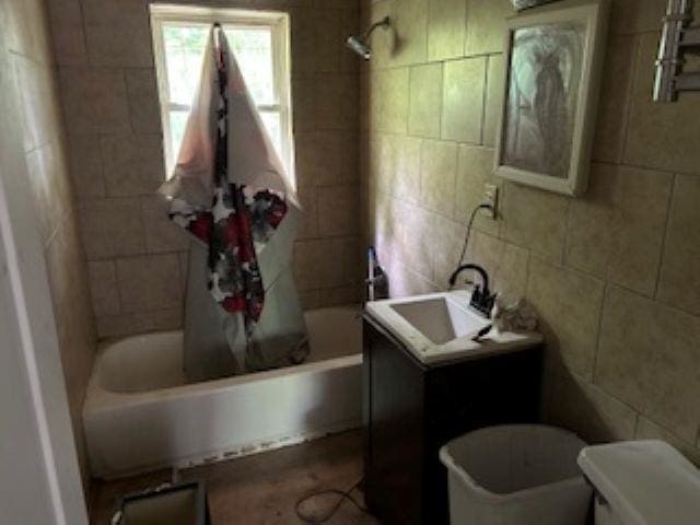 2602 Sloan St, Flint, MI 48504 - bathroom with shower / bath combination with curtain, toilet, tile walls, and vanity