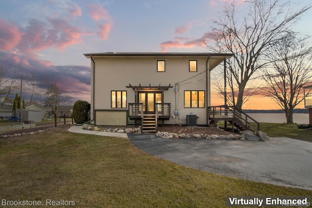 2995 Venice, Highland, MI 48356 - view of front of home with stairs, a deck, central AC, and a pergola