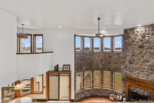 2995 Venice, Highland, MI 48356 - living room with a large fireplace, plenty of natural light, wood finished floors, recessed lighting, and a ceiling fan