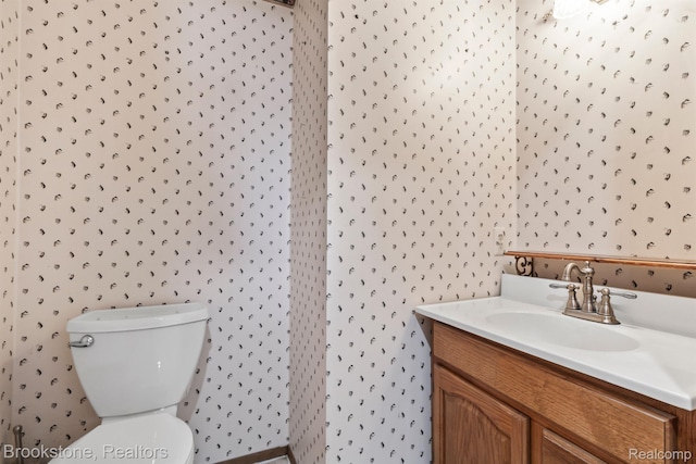 2995 Venice, Highland, MI 48356 - bathroom featuring vanity, wallpapered walls, and toilet