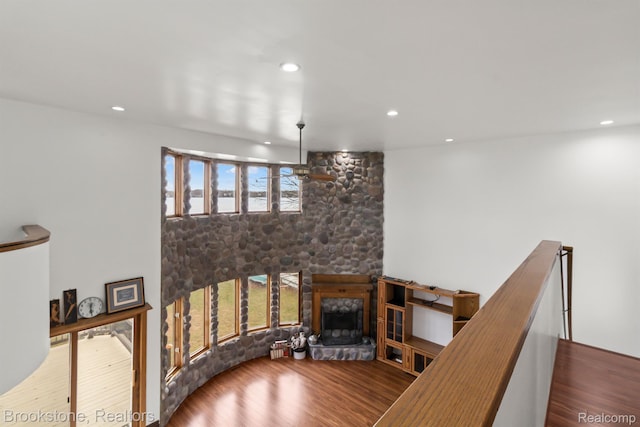 2995 Venice, Highland, MI 48356 - staircase featuring wood finished floors, a stone fireplace, and recessed lighting