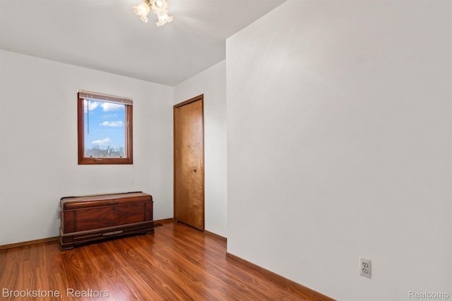 2995 Venice, Highland, MI 48356 - spare room featuring wood finished floors and baseboards