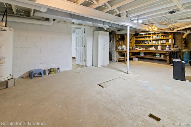 2995 Venice, Highland, MI 48356 - unfinished basement featuring a workshop area, water heater, a water pressure tank, and concrete block wall
