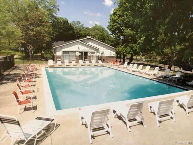 2356 Orchard Crest St, Shelby Twp, MI 48317 - community pool featuring a patio area and view of wooded area