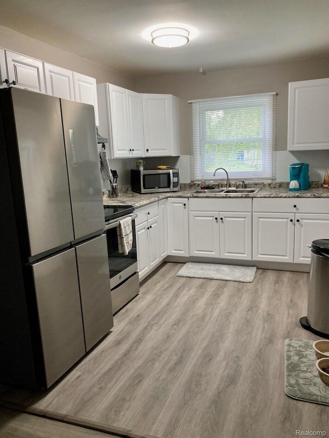 630 Aldrich St, Linden, MI 48451 - kitchen featuring appliances with stainless steel finishes, a sink, and white cabinetry