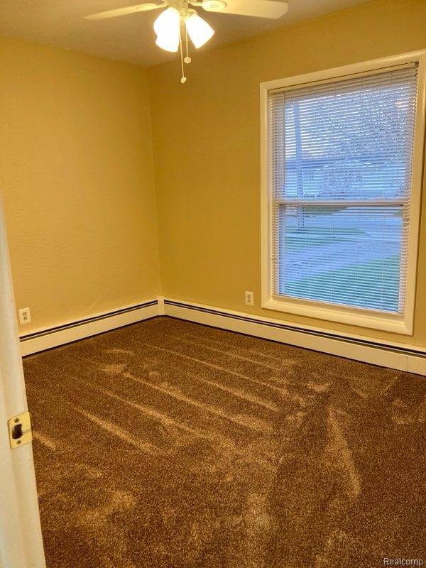 630 Aldrich St, Linden, MI 48451 - carpeted empty room with ceiling fan