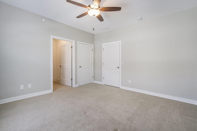 603 Woodland, Dexter, MI 48130 - unfurnished bedroom featuring light colored carpet, baseboards, and ceiling fan
