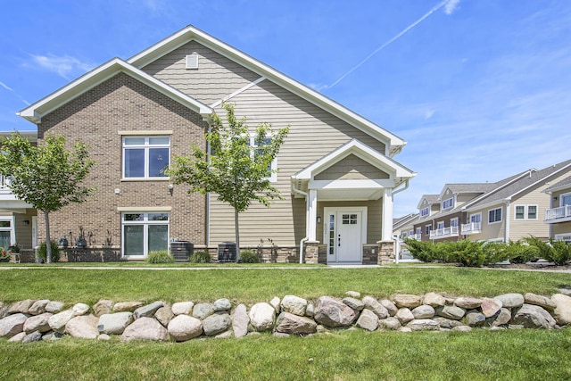 603 Woodland, Dexter, MI 48130 - view of front of house featuring a front lawn and brick siding