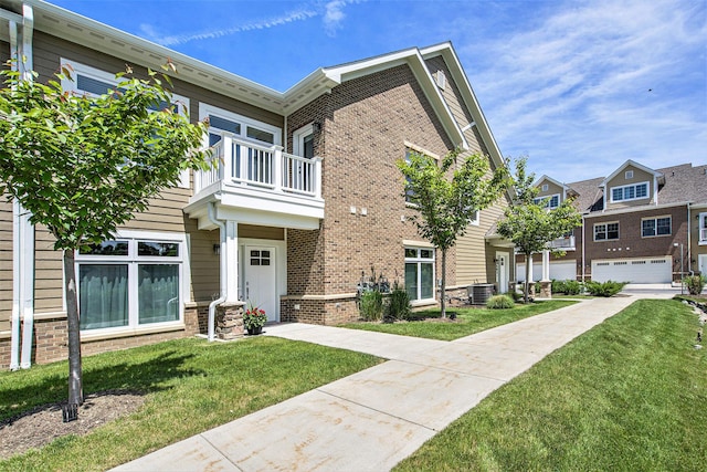 603 Woodland, Dexter, MI 48130 - view of front of property with a balcony, central air condition unit, and brick siding