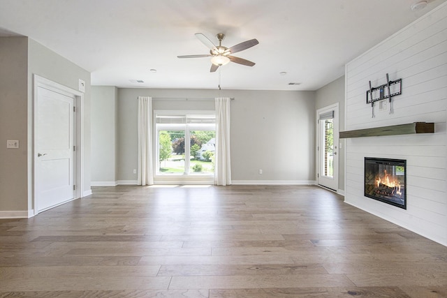 603 Woodland, Dexter, MI 48130 - unfurnished living room with hardwood / wood-style floors, a ceiling fan, and healthy amount of natural light