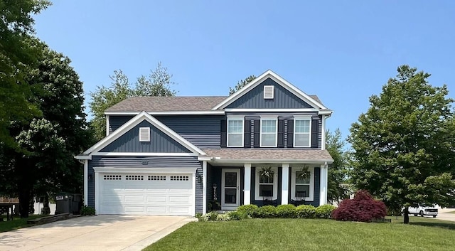 5855 Larson Ln, Muskegon, MI 49444 - traditional home with driveway, a front lawn, and covered porch