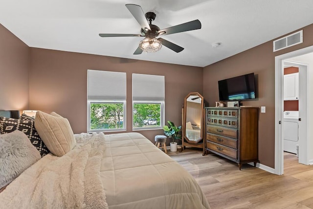 5855 Larson Ln, Muskegon, MI 49444 - bedroom with washer / clothes dryer, wood finished floors, baseboards, and a ceiling fan