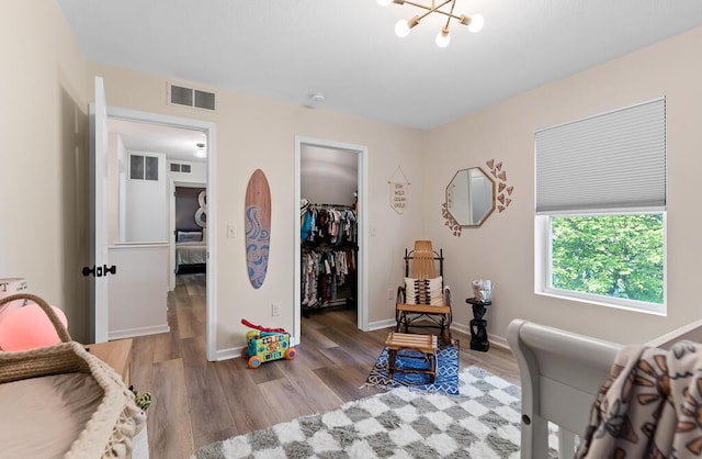 5855 Larson Ln, Muskegon, MI 49444 - sitting room with wood finished floors, a chandelier, and baseboards