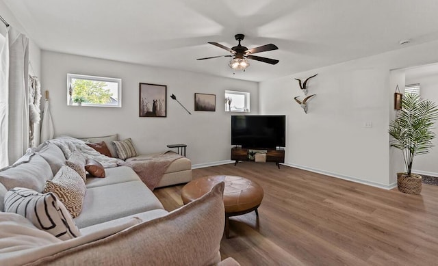 5855 Larson Ln, Muskegon, MI 49444 - living room featuring ceiling fan, wood finished floors, and baseboards