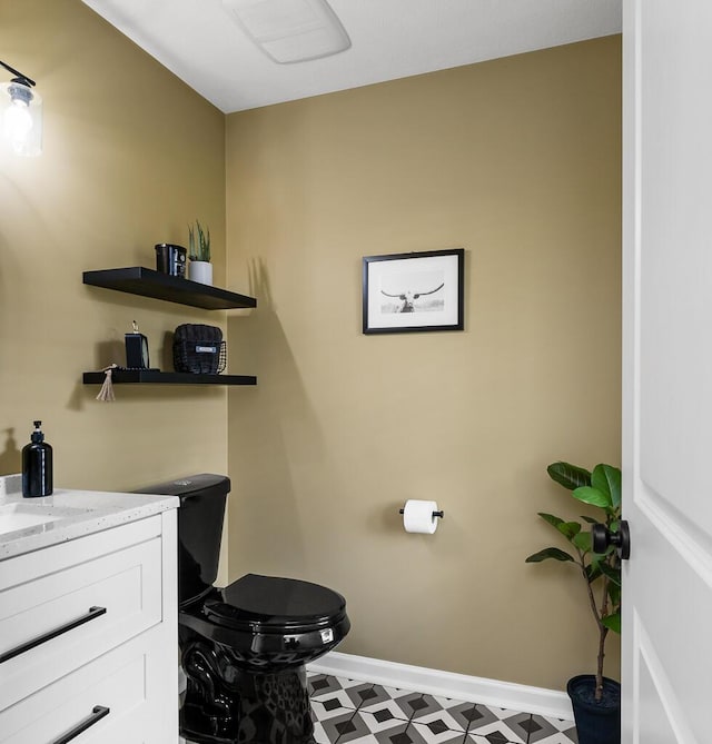 5855 Larson Ln, Muskegon, MI 49444 - bathroom with tile patterned floors, vanity, toilet, and baseboards