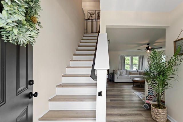 5855 Larson Ln, Muskegon, MI 49444 - staircase with a ceiling fan and wood finished floors